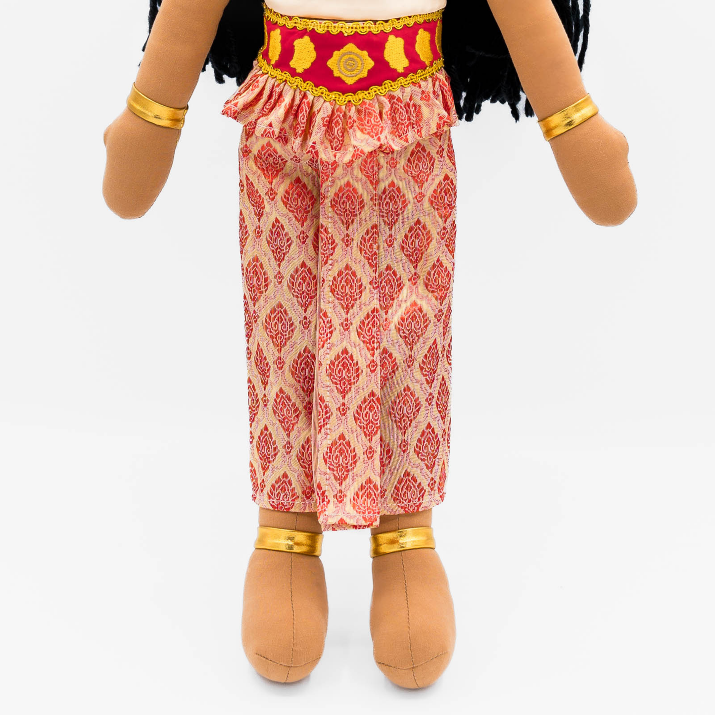 Close-up of Soriya Cambodian cultural doll outfit featuring a pink patterned sampot skirt, gold-red belt, and gold jewelry