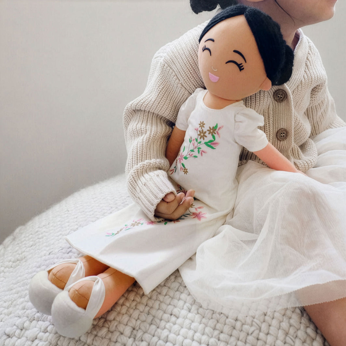 Girl holding Joeydolls Malaya Filipina doll in her lap