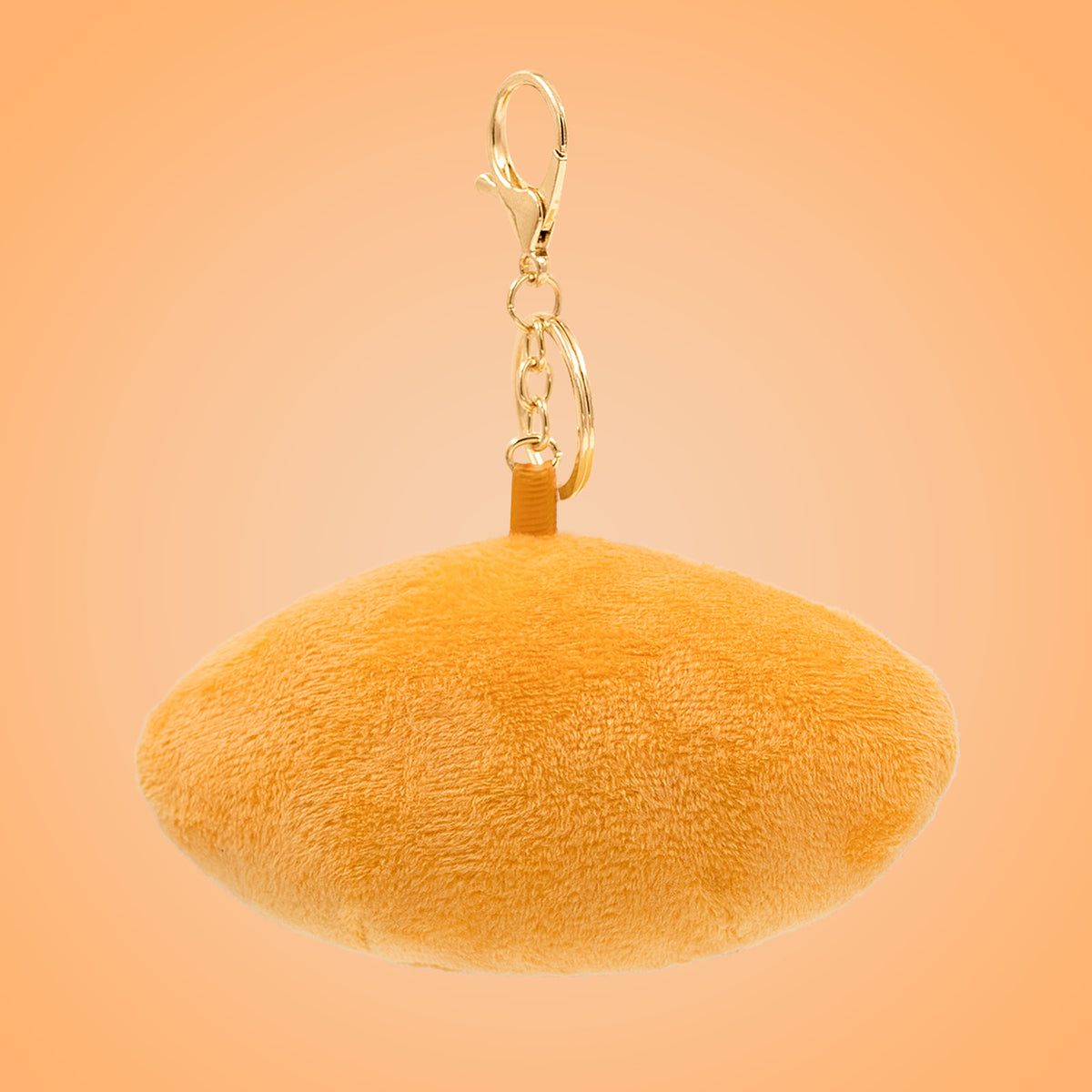 Back view of Vietnamese bánh mì Food Pals keychain showing a soft sandwich shape with a gold clasp