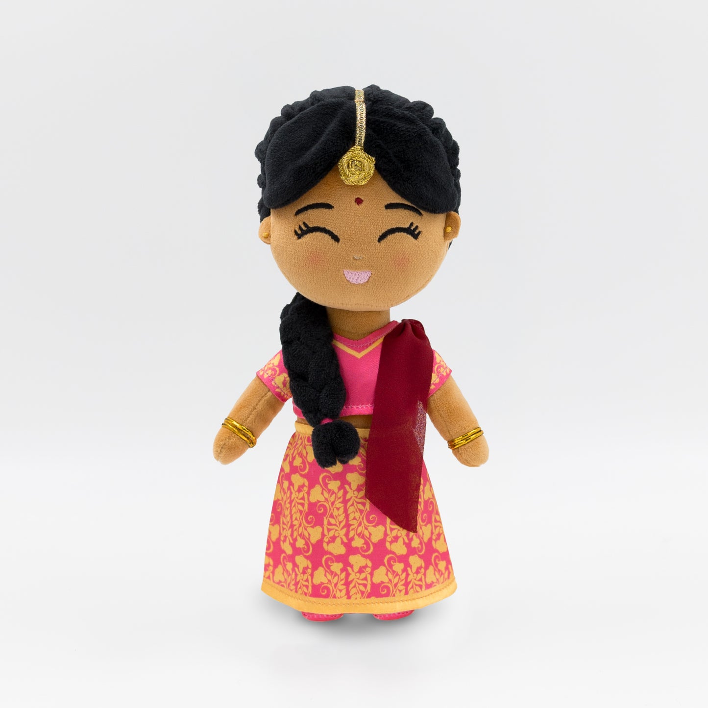 Indian mini plush doll for kids — Priya wears a traditional pink and gold saree with a red dupatta, gold jewelry, and braided hair. A soft, inclusive doll that introduces Indian culture through screen-free play.