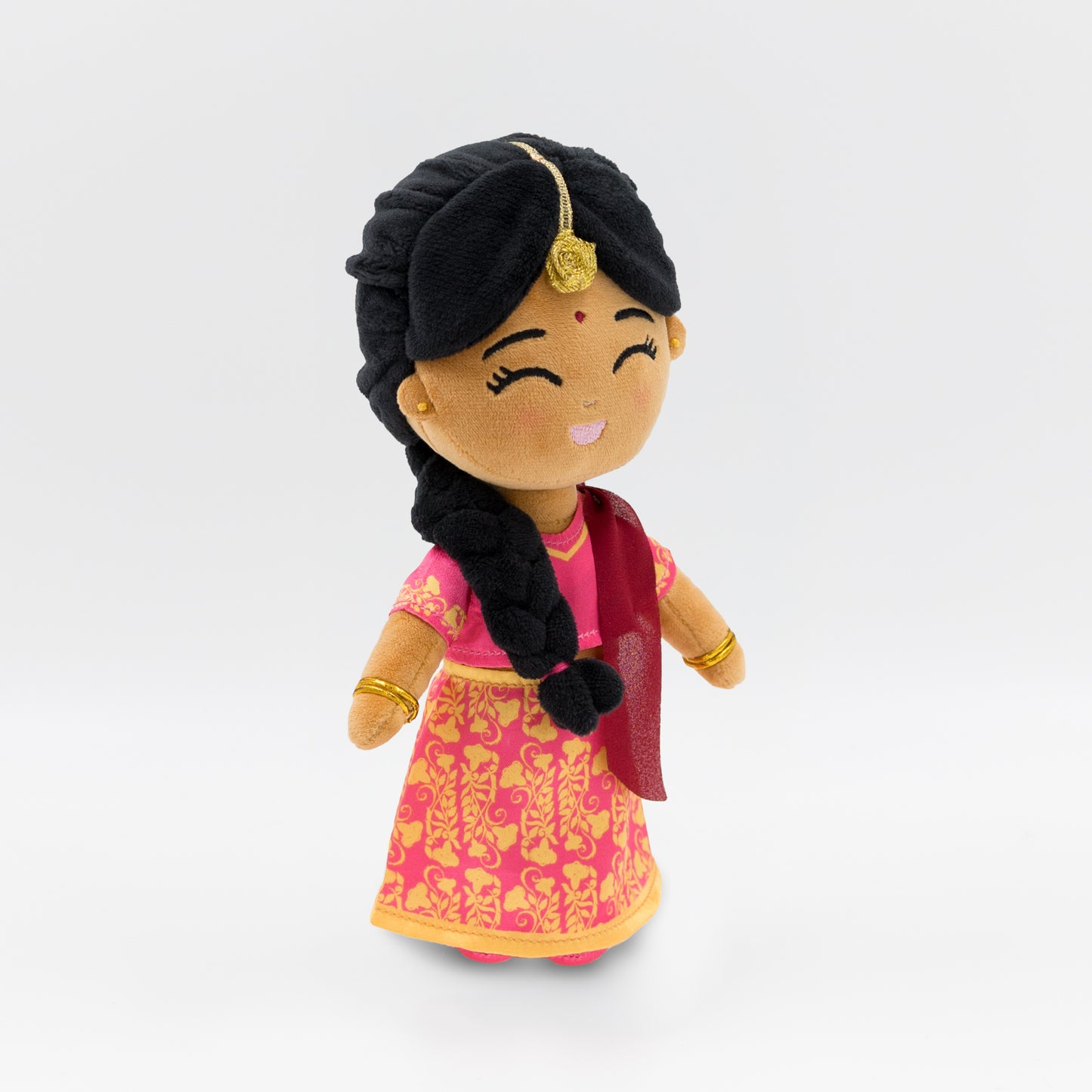 Side view of Indian cultural plush doll Priya, showing her pink blouse, red dupatta, and traditional gold jewelry — a soft toy celebrating Indian heritage for toddlers and preschoolers.