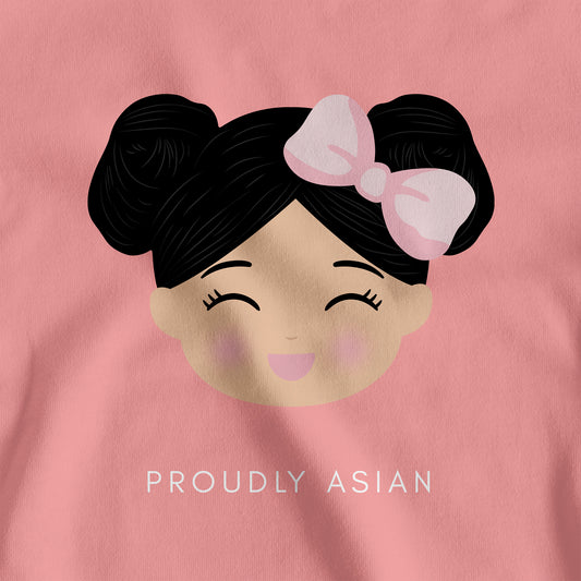 Close-up of the printed illustration on the Proudly Asian women’s t-shirt featuring a smiling girl’s face with the text “PROUDLY ASIAN” below.