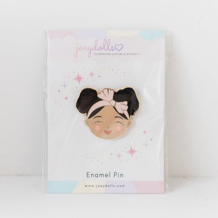 Joeydolls Cheerful Jasmine gold enamel pin packaged on a Joeydolls card in a clear sleeve, featuring a smiling girl character with double buns and a pink headband.