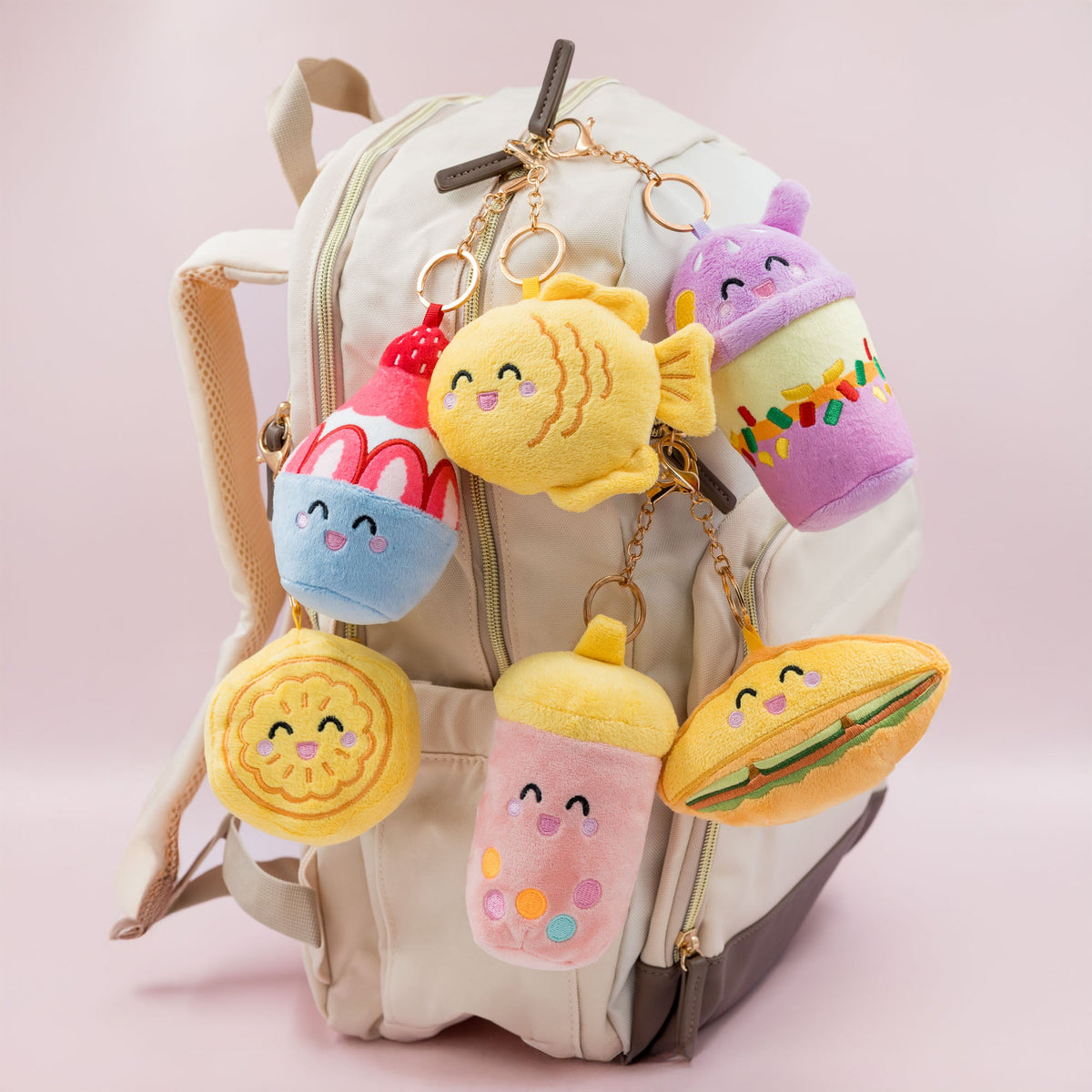 
A group of Joeydolls Food Pals plush bag charms with smiling faces

