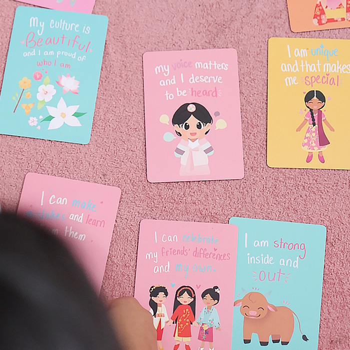 Colorful affirmation cards spread out showing positive messages about confidence, identity, and kindness