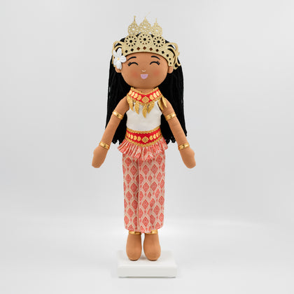 Soriya Cambodian cultural doll wearing a white top and embroidered pink sampot skirt with a gold-red belt, adorned with a gold mokot ksatrey crown and Champei flower in her hair