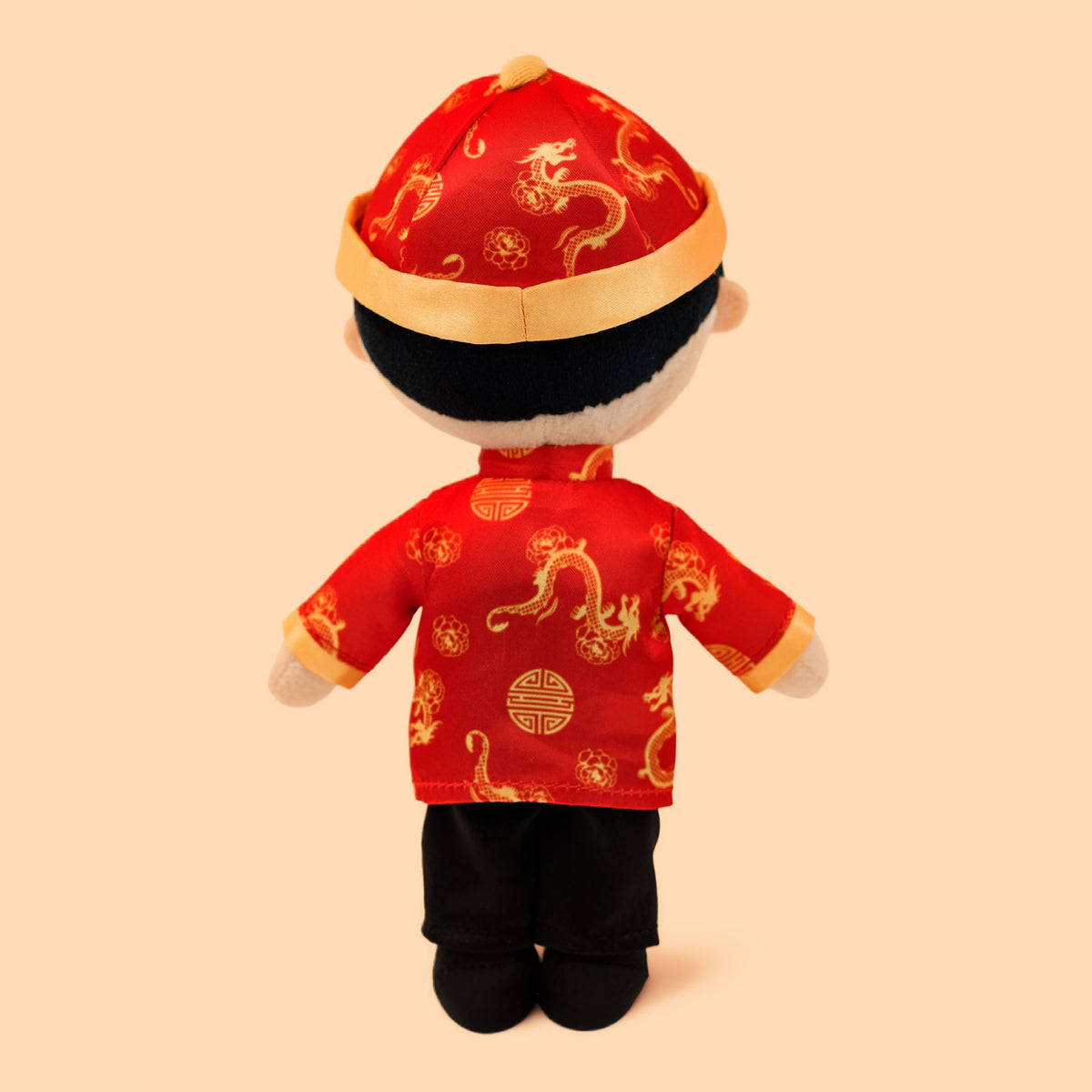 Back view of the Chinese Boy Cultural Mini Doll displayed in traditional Chinese outfit with a red jacket and hat 
