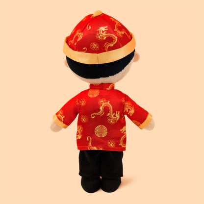 Back view of the Chinese Boy Cultural Mini Doll displayed in traditional Chinese outfit with a red jacket and hat 