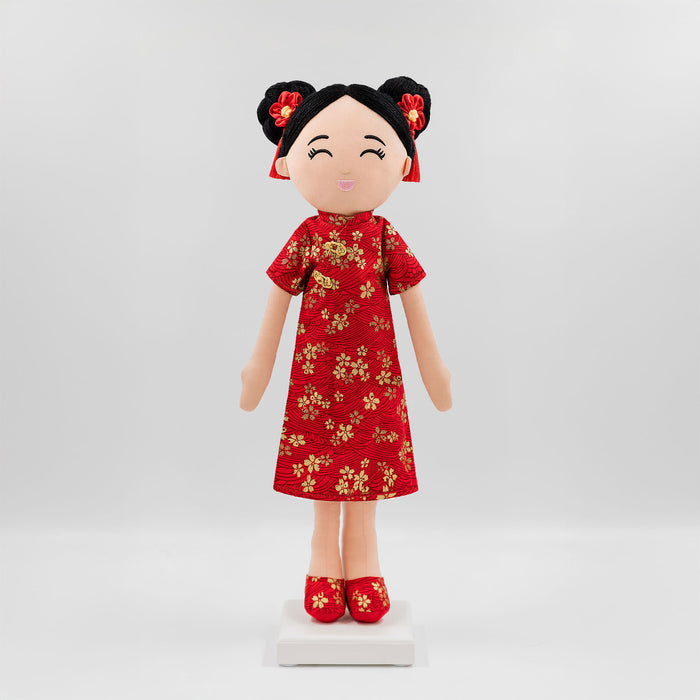 Mei Chinese cultural doll in a traditional qi pao dress with gold pattern