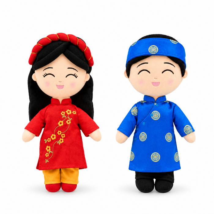 Two Vietnamese cultural mini dolls wearing a blue áo dài and a red áo dài with a khăn đóng headpiece.