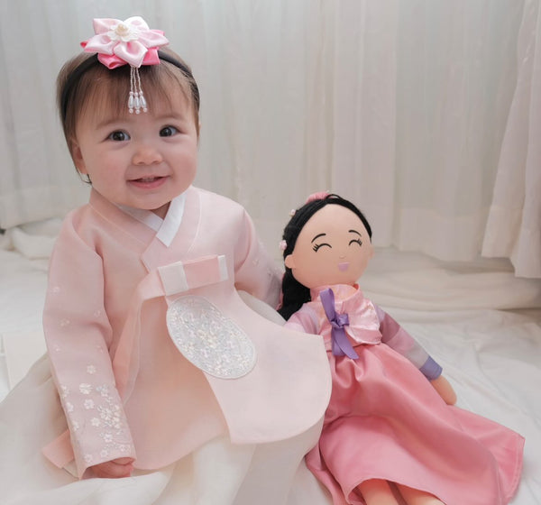 Child with a Korean Danbi cultural doll