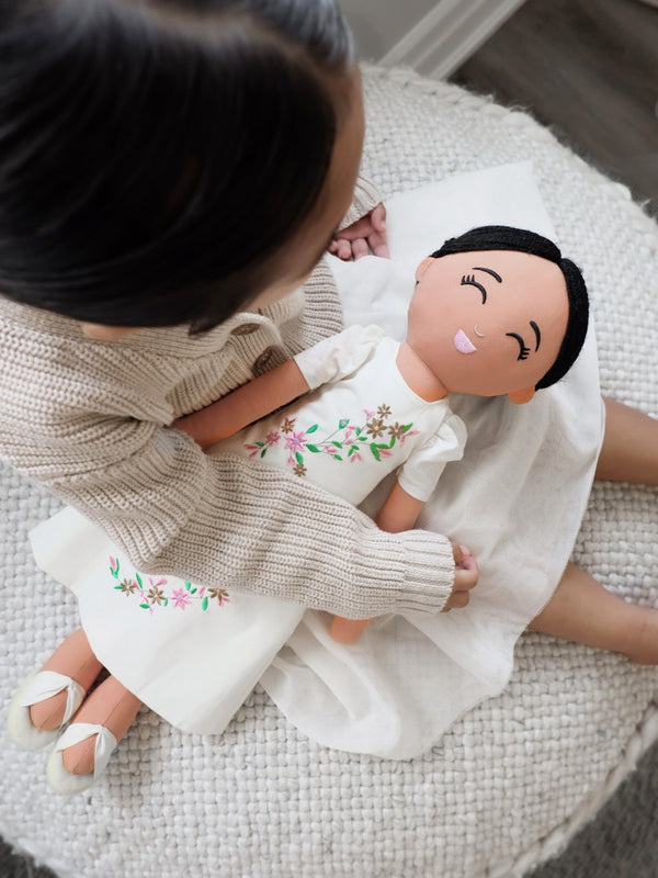 Child with a Filipina cultural doll