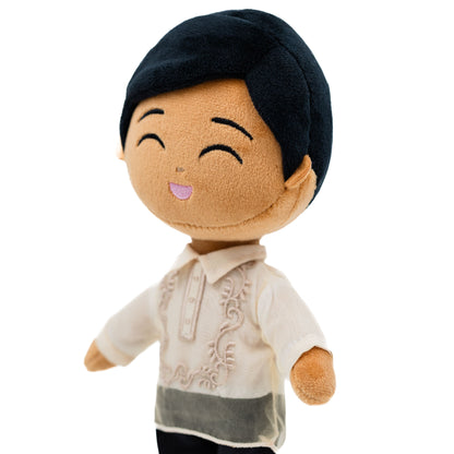 Close-up of a smiling Filipino boy plush doll wearing a cream Barong Tagalog-inspired outfit with embroidered details and black hair.