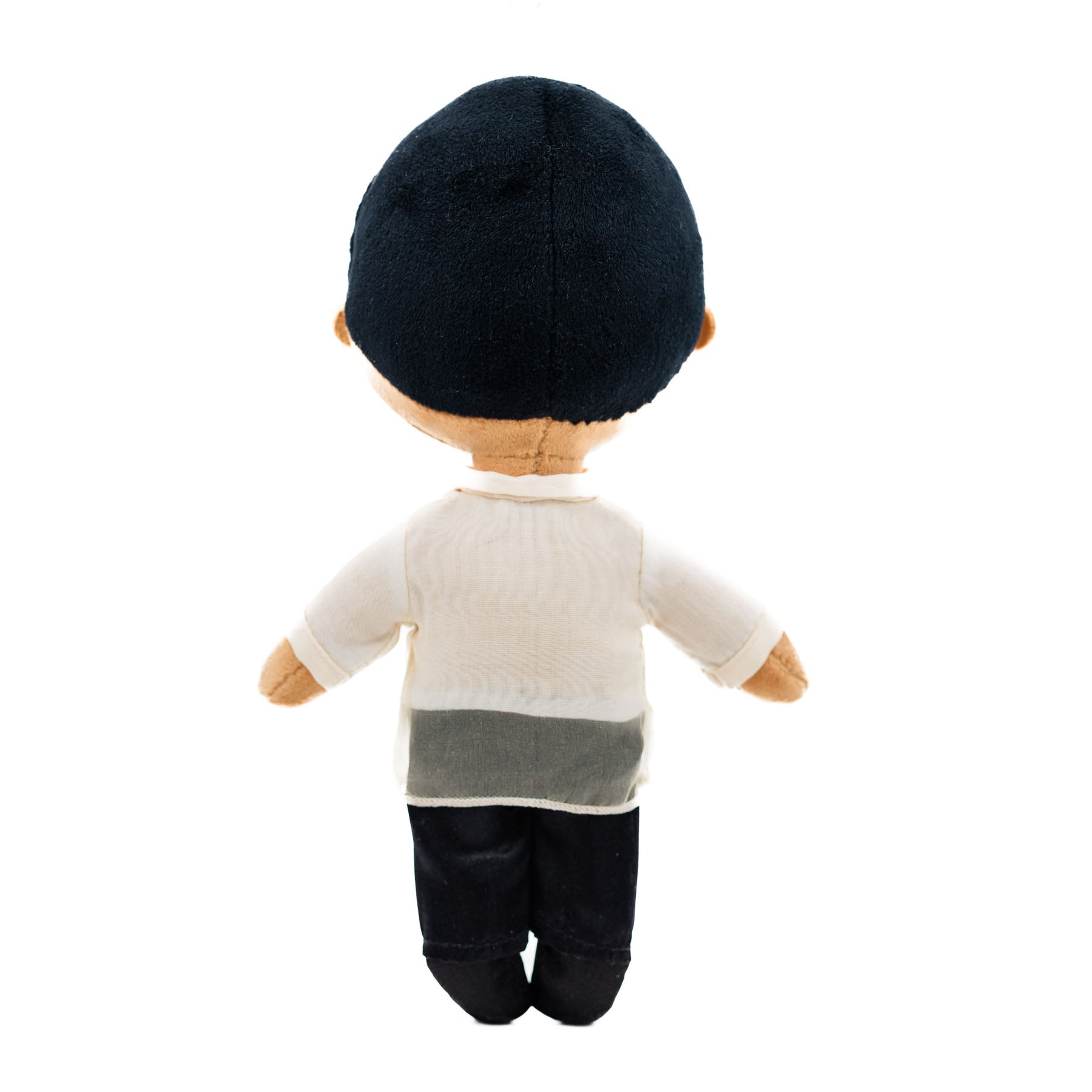 Back view of a Filipino boy plush doll wearing a traditional cream Barong Tagalog-inspired shirt with black pants and short black hair against a white background.
