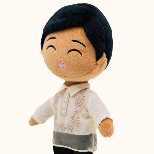 Close-up side view of Bayani Filipino boy mini doll wearing a Barong Tagalog-inspired outfit featuring embroidered details on the traditional cream shirt.