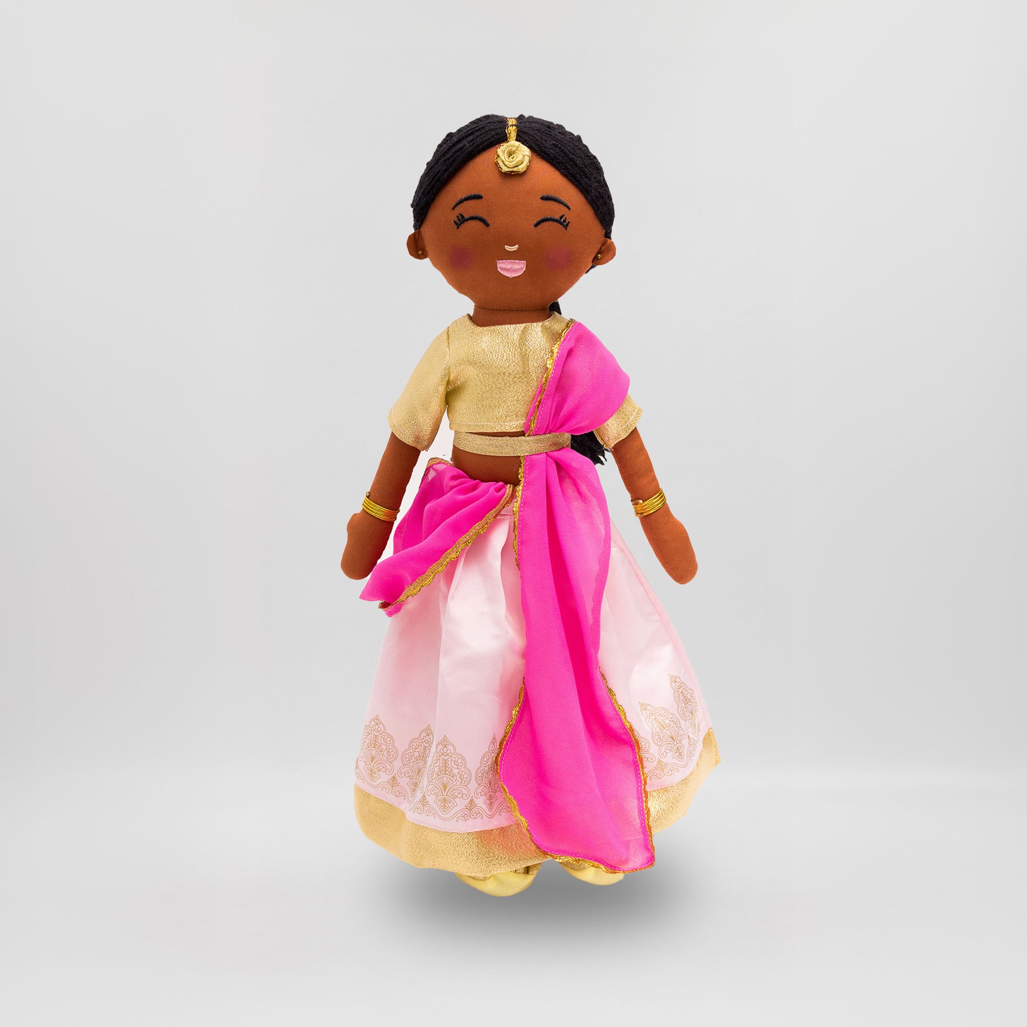 Kamala, the Joeydolls Indian doll, wearing a pink lehenga with gold embroidery, a gold choli and a pink dupatta.