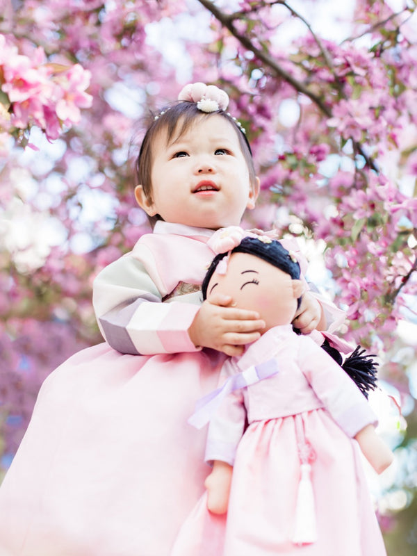 Child with a Korean hanbok doll