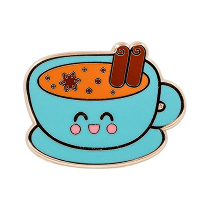 Indian masala chai enamel pin featuring a smiling blue teacup filled with chai, topped with cinnamon sticks and star anise.