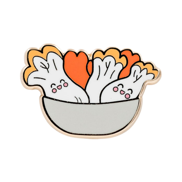Kimchi Korean fermented cabbage enamel pin featuring smiling napa cabbage pieces in a bowl with red and orange kimchi seasoning.