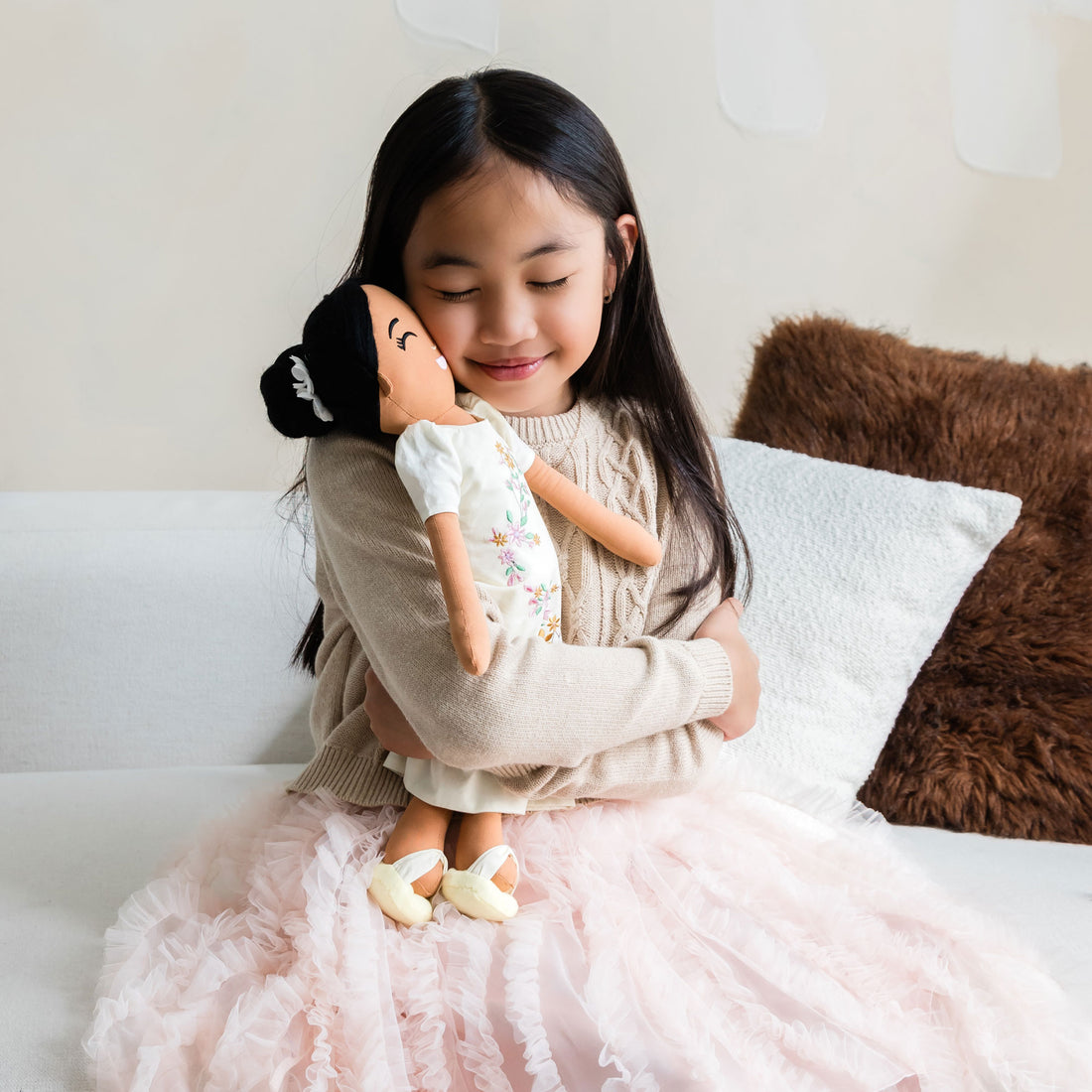 Child hugging Malaya Filipina cultural doll, showing emotional connection and companionship