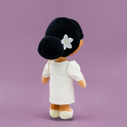 Back view of Malaya Filipina cultural mini doll showing a Filipiniana dress and a low bun hairstyle with a white floral accessory