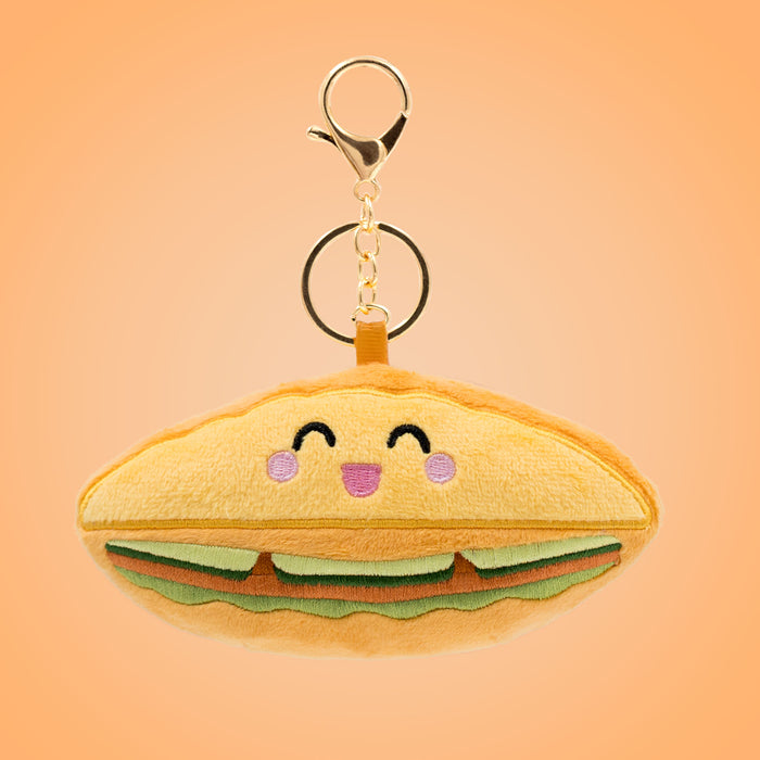Vietnamese bánh mì Food Pals keychain featuring a smiling sandwich design with layered fillings and a gold clasp