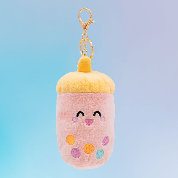 Taiwanese boba Food Pals bag charm featuring a smiling pink cup, a yellow lid, colorful tapioca pearls, and a gold clasp