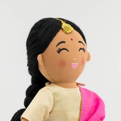 Close-up of Priya doll face showing braided hairstyle, bindi, and tikka detail