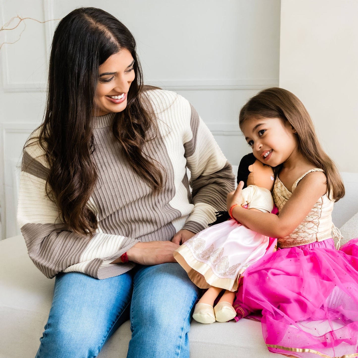 Woman and child playing with Priya Indian cultural doll, showing bonding and shared play