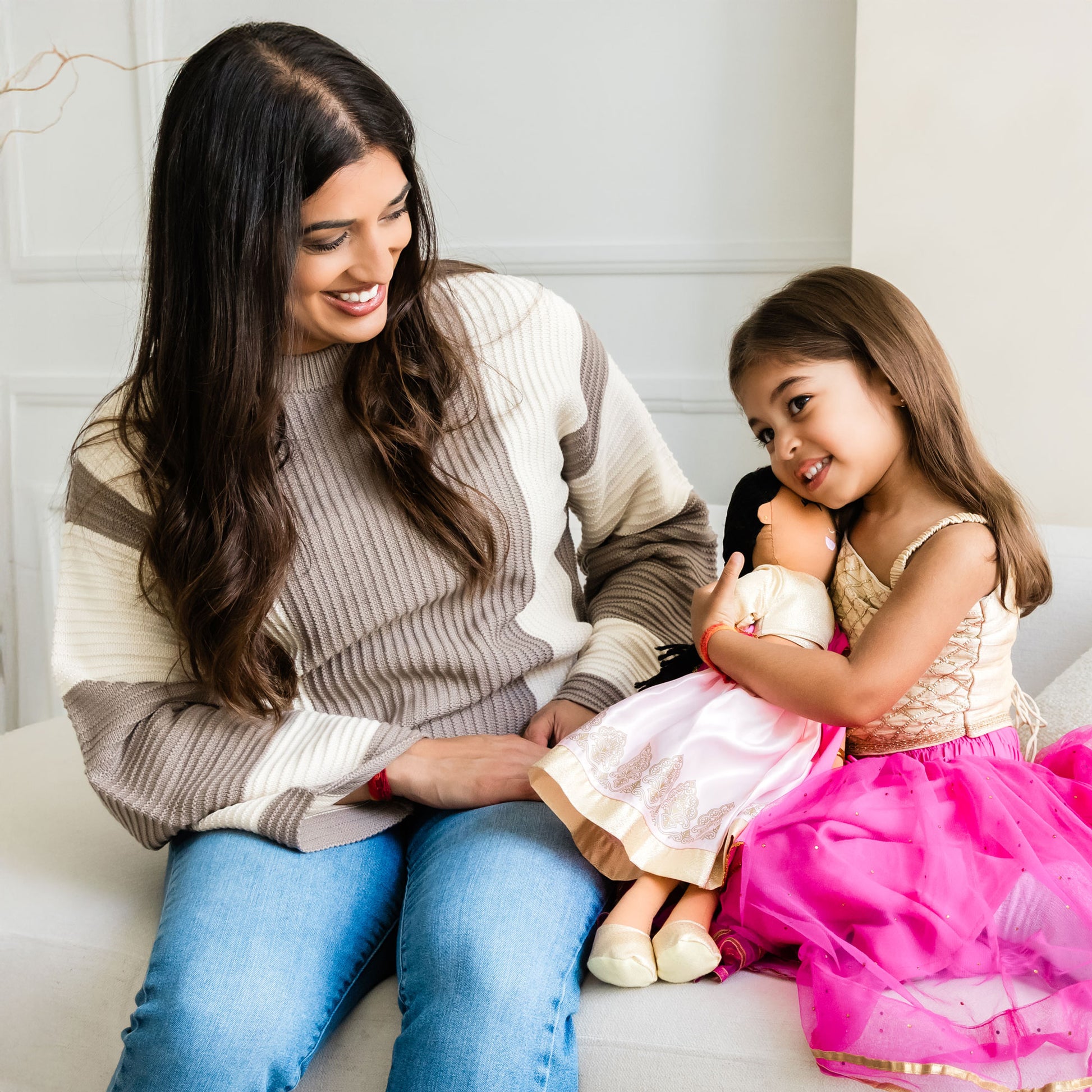 Woman and child playing with Priya Indian cultural doll, showing bonding and shared play