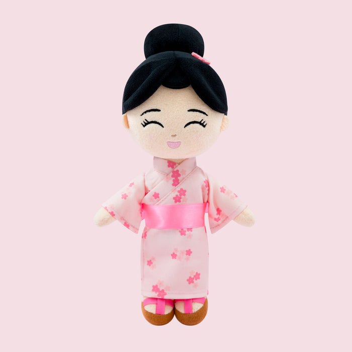 Aiko Japanese cultural mini doll wearing a pink floral kimono, obi sash, and a bun with accessory