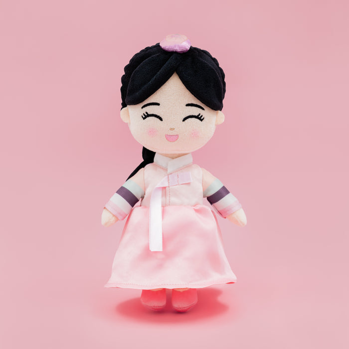 Danbi Korean cultural mini doll wearing a pink hanbok with a braid and pink shoes.