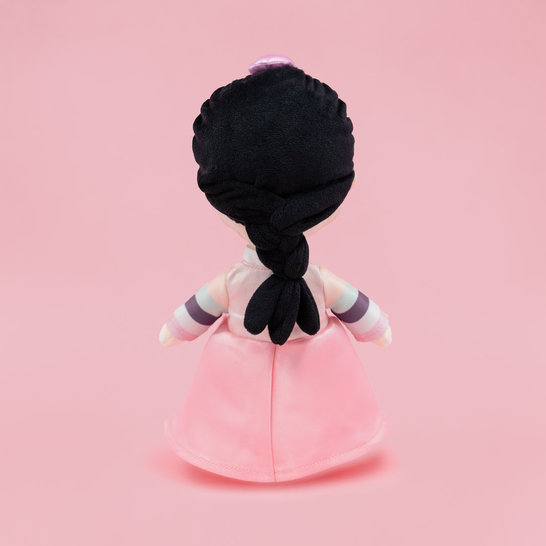 Back view of Danbi Korean cultural mini doll showing a long black braid and a pink hanbok