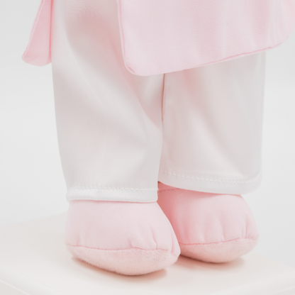 Close-up of Thuong Vietnamese cultural doll wearing white satin pants and soft pink shoes
