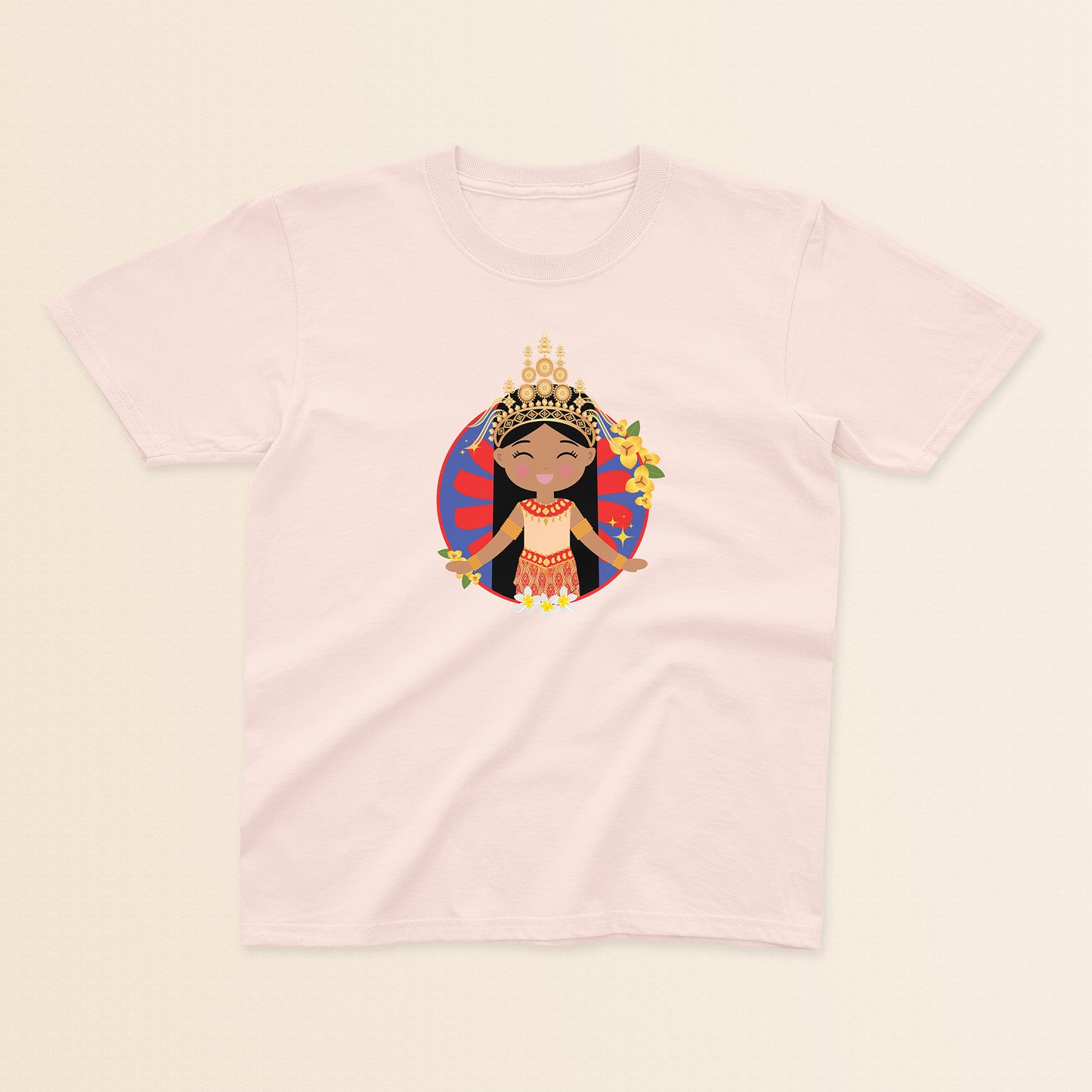 Cambodian Cultural Celebration baby and kids tee in light pink featuring a smiling girl wearing a sampot and a mokot ksatrey crown, set against a red and blue circular background with champei flowers.