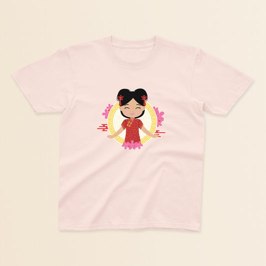 Chinese Cultural Celebration baby and kids tee in light pink featuring a smiling girl with black hair styled in double buns and red accessories, wearing a red and gold qipao, set against a circular gold pattern with pink floral details.
