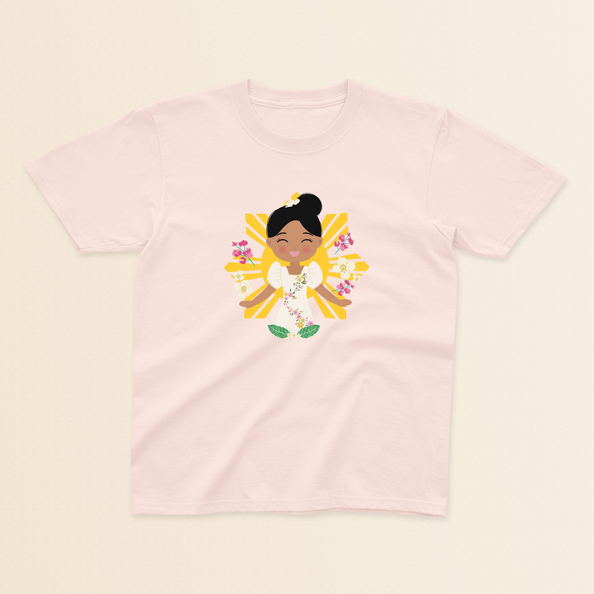 Filipina Cultural Celebration baby and kids t-shirt in light pink with a graphic of a smiling girl wearing a floral Filipiniana dress, hair in a bun, set against a Filipino sun and surrounded by floral elements.