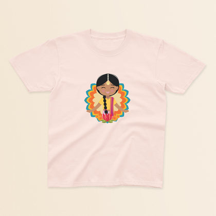 Indian Cultural Celebration baby and kids t-shirt in light pink with a graphic of a smiling girl with long black braided hair with gold maang tikka, wearing a yellow lehenga paired with pink dupatta, set against a mandala-inspired decorative background with a lotus flower at the bottom.