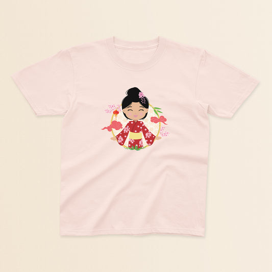 Japanese Cultural Celebration baby and kids t-shirt in light pink with a graphic of a smiling girl with her hair in a high bun with a pink flower, wearing a red sakura-patterned kimono with a yellow obi sash, set against a circular background with cherry blossoms and traditional elements.