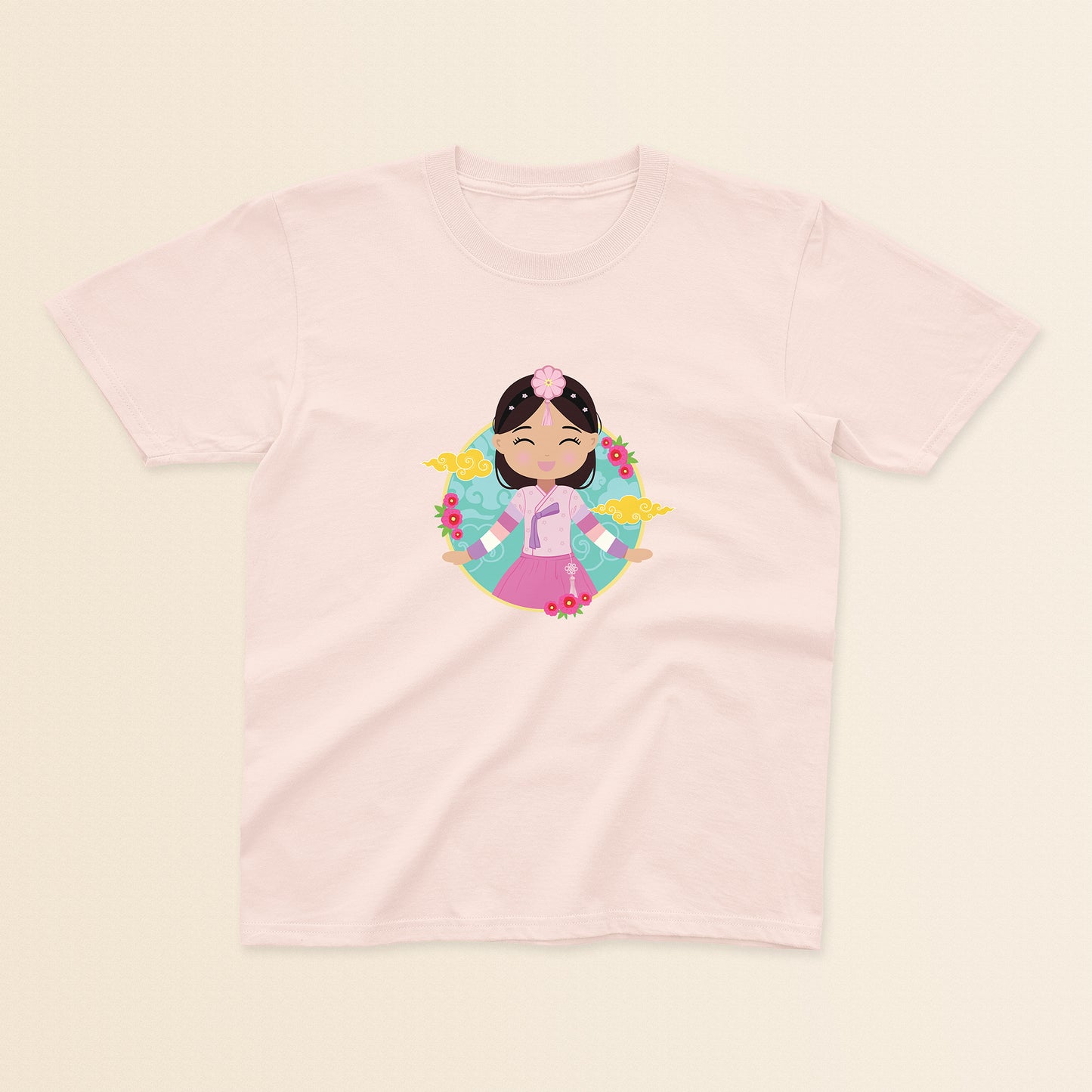 Korean Cultural Celebration baby and kids t-shirt in light pink with a graphic of a smiling girl with long hair adorned with a daenggi ribbon and a jokduri headpiece, wearing a pink hanbok with a norigae ornament, set against a circular background with floral elements and traditional patterns.