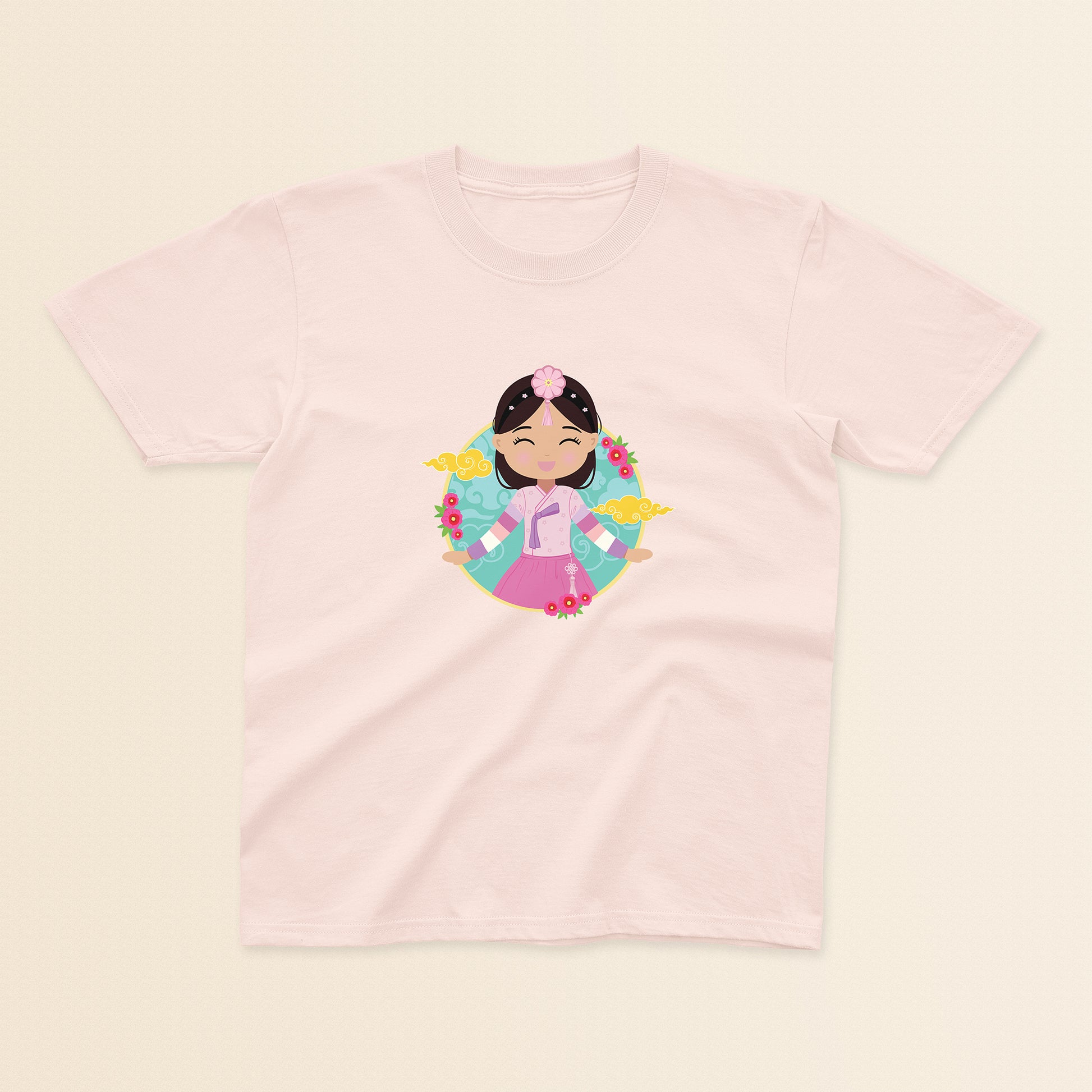 Korean Cultural Celebration baby and kids t-shirt in light pink with a graphic of a smiling girl with long hair adorned with a daenggi ribbon and a jokduri headpiece, wearing a pink hanbok with a norigae ornament, set against a circular background with floral elements and traditional patterns.
