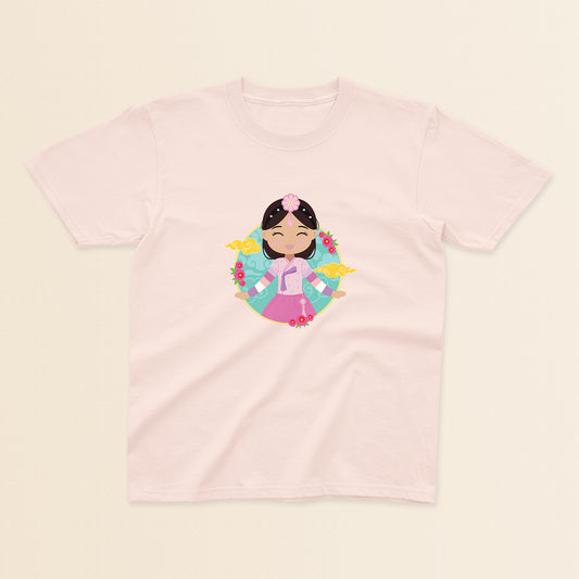 Korean Cultural Celebration baby and kids t-shirt in light pink with a graphic of a smiling girl with long hair adorned with a daenggi ribbon and a jokduri headpiece, wearing a pink hanbok with a norigae ornament, set against a circular background with floral elements and traditional patterns.