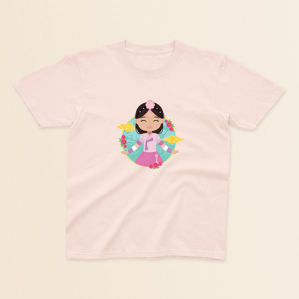 Korean Cultural Celebration baby and kids t-shirt in light pink with a graphic of a smiling girl with long hair adorned with a daenggi ribbon and a jokduri headpiece, wearing a pink hanbok with a norigae ornament, set against a circular background with floral elements and traditional patterns.