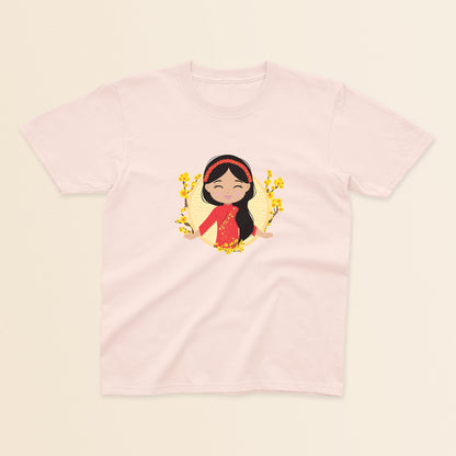 Vietnamese Cultural Celebration baby and kids tee in light pink featuring a printed illustration of a smiling girl with long black hair, wearing a red áo dài featuring delicate mai flower details and a traditional khăn đóng headpiece, set against a circular yellow background with floral elements.