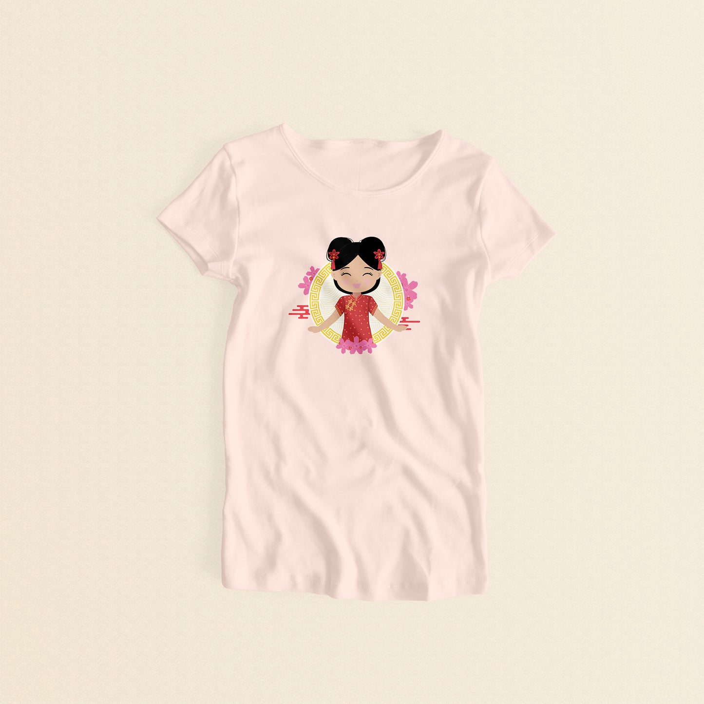 Chinese Cultural Celebration women’s tee in light pink featuring a printed illustration of a smiling girl with her hair in two buns adorned with red accessories, wearing a vibrant red and gold qipao, set against a circular gold pattern with pink floral elements.