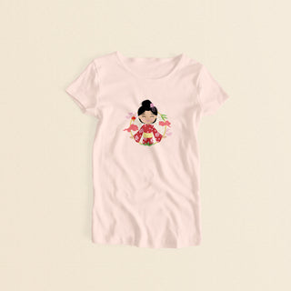 Japanese Cultural Celebration women’s t-shirt in light pink with a graphic of a smiling girl with her hair in a high bun with a pink flower, wearing a red sakura-patterned yukata with a yellow obi sash, set against a circular background with cherry blossoms and traditional elements.