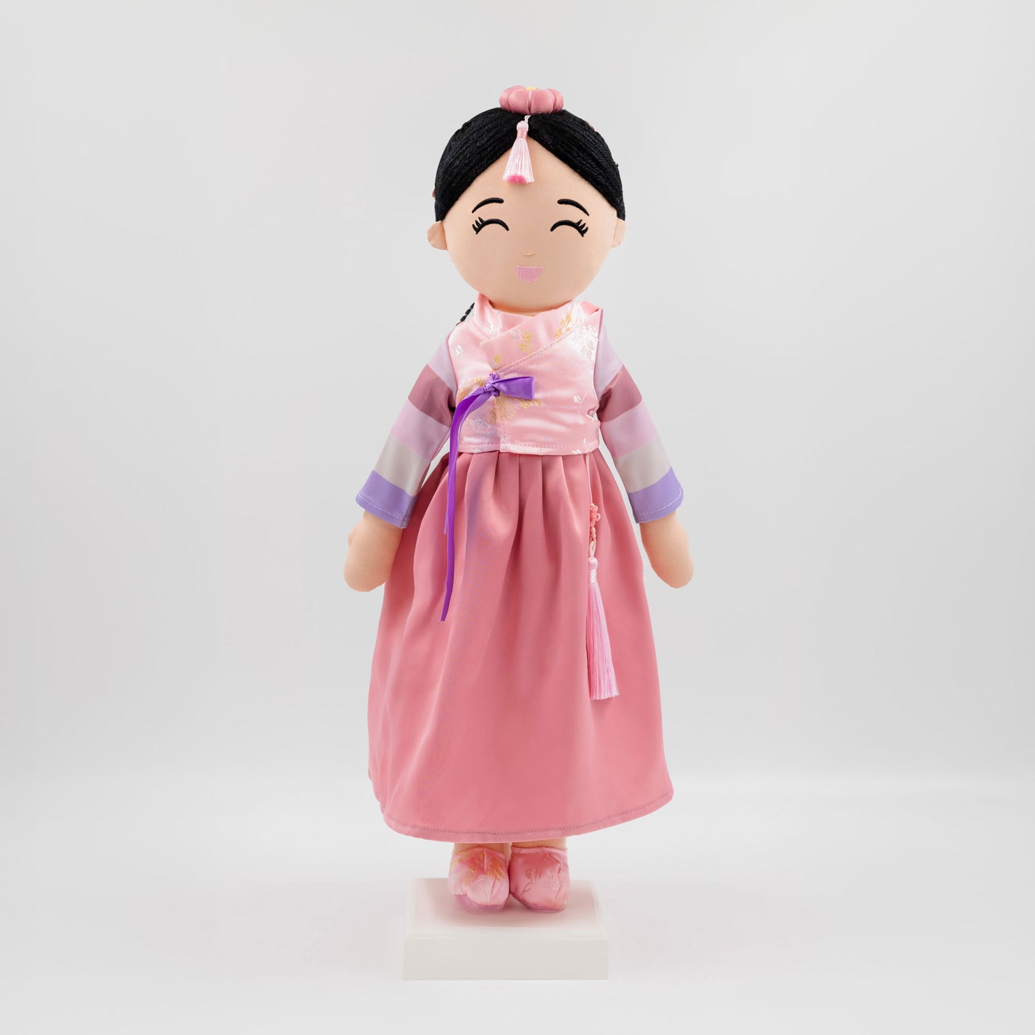 Joeydolls Danbi Korean cultural doll wearing a traditional pink hanbok with pastel striped sleeves, a pink jokduri headpiece, and a norigae tassel