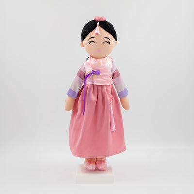 Joeydolls Danbi Korean cultural doll wearing a traditional pink hanbok with pastel striped sleeves, a pink jokduri headpiece, and a norigae tassel