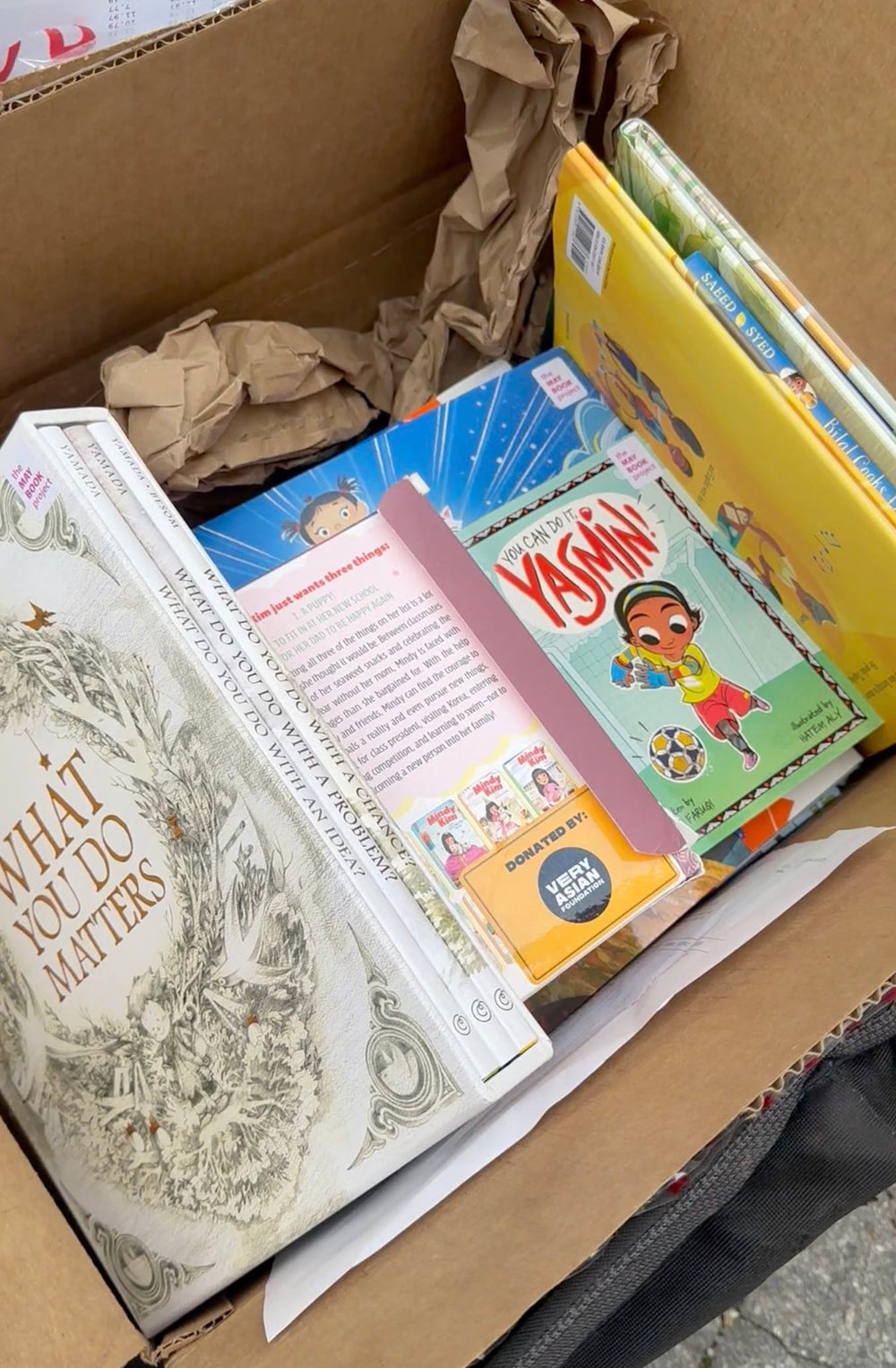 A box of diverse children’s books for the May Book Project