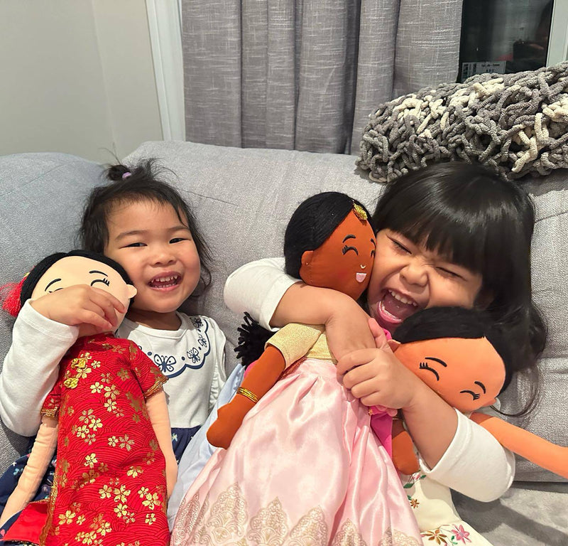 Kids smiling and hugging their Joeydolls cultural dolls